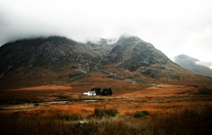 Mountain in Scotland with small house