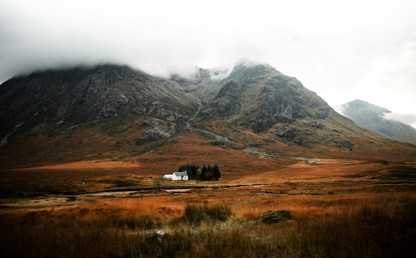 Mountain in Scotland with small house