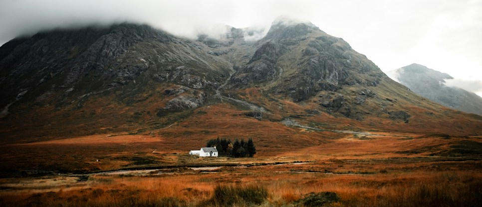 Mountain in Scotland with small house